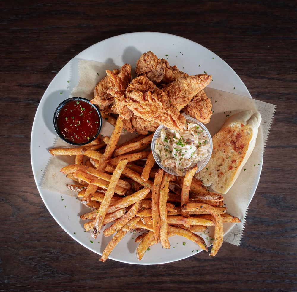 Hand-breaded buttermilk chicken tenders with house-cut fries and slaw