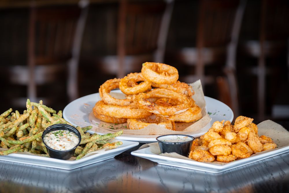 A trio of fried starters: onion rings, green beans, and popcorn shrimp