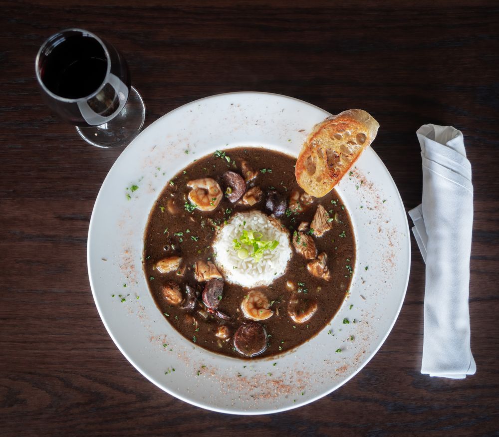 A bowl of gumbo with a mound of rice at the center