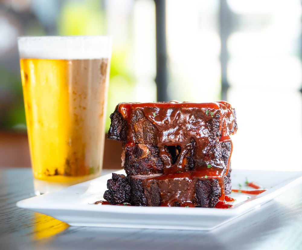 Slow-smoked BBQ ribs drizzled with house-made barbecue sauce